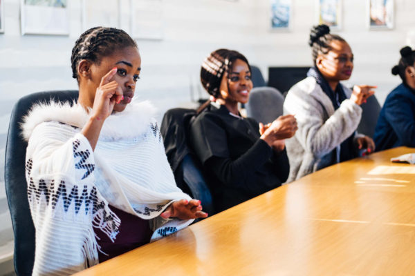 People communicating in South African Sign Language at NID